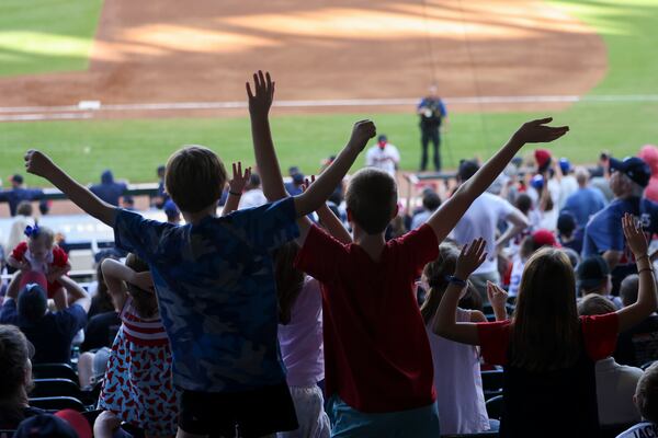 Atlanta Braves fans try to get a ball during the Atlanta Braves post season workout in preparation for the MLB Playoffs at Truist Park, Tuesday, October 3, 2023, in Atlanta. The Braves first playoff game will be on Saturday, Oct. 7, 2023 at Truist Park for game one of the NLDS. (Jason Getz / Jason.Getz@ajc.com)