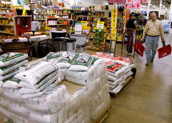 A worker of a hardware store walks past a pallet of ice melt while restocking a display of snow shovels in Winston-Salem, N.C., Wednesday, Jan. 20, 2016. Forecasters warned residents of North Carolina on Wednesday to brace for what it calls a significant winter storm that could dump snow, sleet and ice and make driving hazardous. (AP Photo/Skip Foreman)