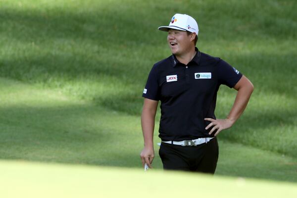 Sungjae Im talks with fellow golfers on the 10th hole during the third round of the Masters Saturday at Augusta National. (Curtis Compton / Curtis.Compton@ajc.com)

