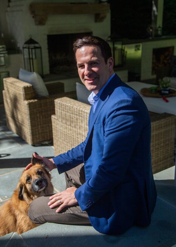 Ryan Cone with his dog Kiya at his Brookhaven home.  PHIL SKINNER FOR THE ATLANTA JOURNAL-CONSTITUTION.