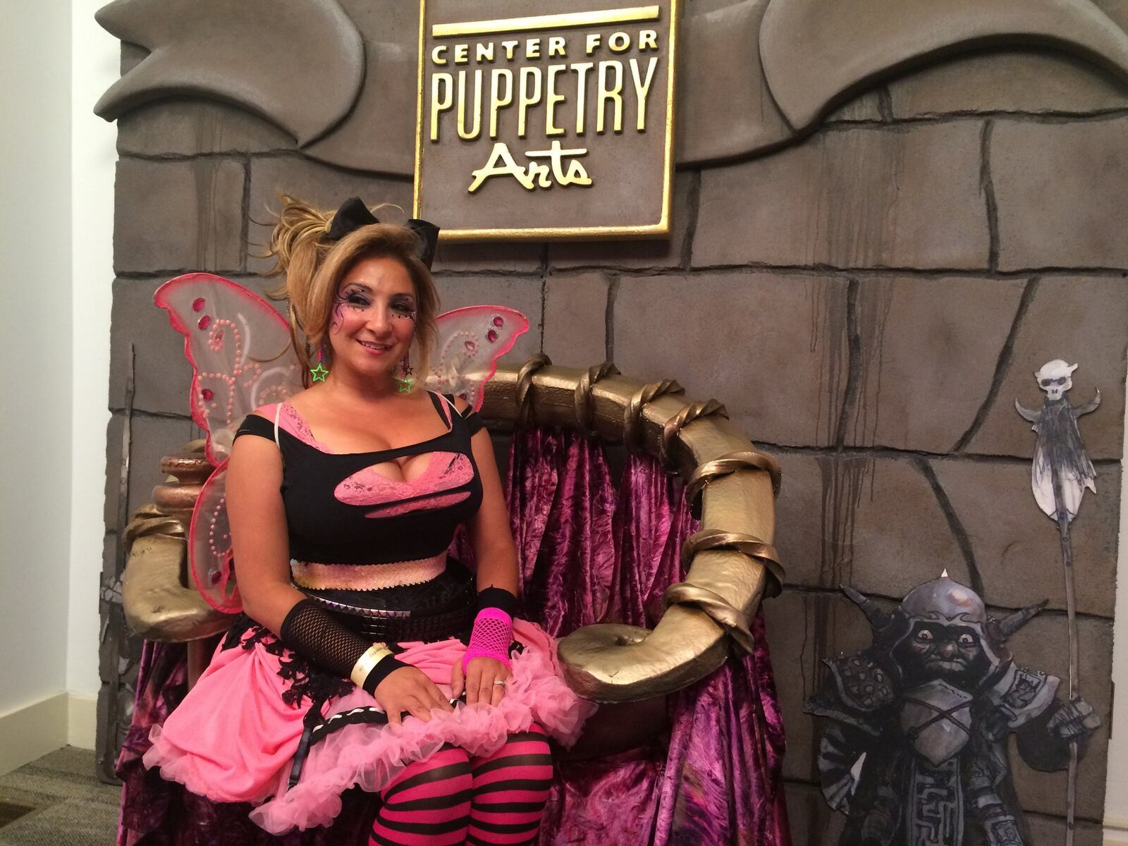 A merrymaker sits in a replica of the Goblin King’s throne from the movie set for “Labyrinth.” The replica was one of the attractions at the Labyrinth Masquerade Ball, which will return to the Center for Puppetry Arts Aug. 31. BO EMERSON / BEMERSON@AJC.COM