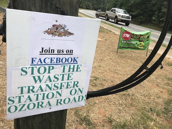 A pair of signs along Ozora Road in near Loganville in Gwinnett County, where neighbors are mounting opposition to a proposed solid waste transfer station. TYLER ESTEP / TYLER.ESTEP@AJC.COM