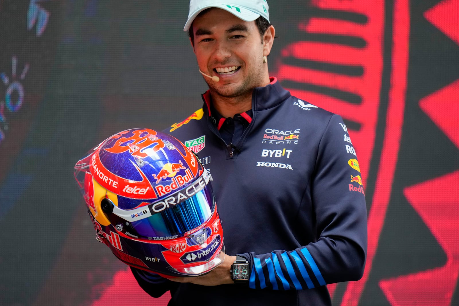 Red Bull driver Sergio Perez, from Mexico, shows his helmet during a press conference in Mexico City, Wednesday, Oct. 23, 2024, ahead of the weekend Formula One Mexico Grand Prix auto race. (AP Photo/Moises Castillo)