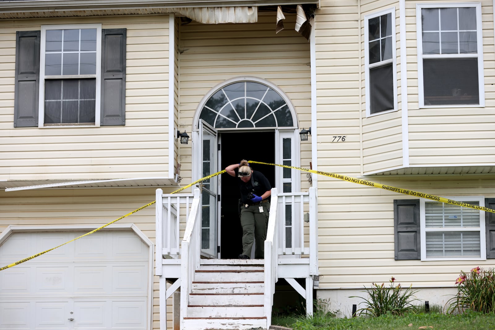 062722 Rockmart, Ga..: A crime scene investigator leaves the home on Woodwind Drive where three children died, Friday in Paulding County, Monday, June 27, 2022, in Rockmart, Ga.. The mother of the children, Darlene Brister, 40, is charged with two counts of malice murder following the deaths. (Jason Getz / Jason.Getz@ajc.com)