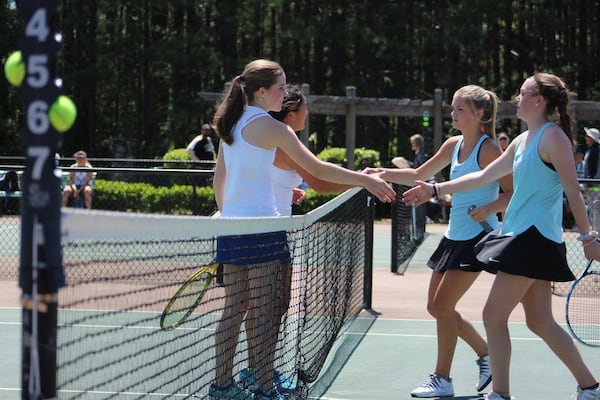  Chamblee's team of Madeline Meer and Madison Trinh shake hands with Strr's Mills' Carolina Kingsley and Megan Fox.