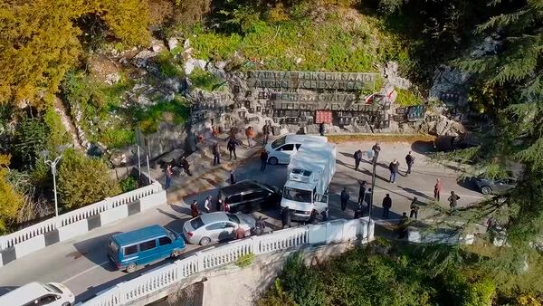 In this photo taken from video released by the Information Center of the President of the Republic of Abkhazia on Tuesday, Nov. 12, 2024, protesters block the way to the bridge over the Gumista River, about 5,5 kilometres south of Sukhumi in the Georgian separatist region of Abkhazia, Georgia. (Information Center of the President of the Republic of Abkhazia via AP)