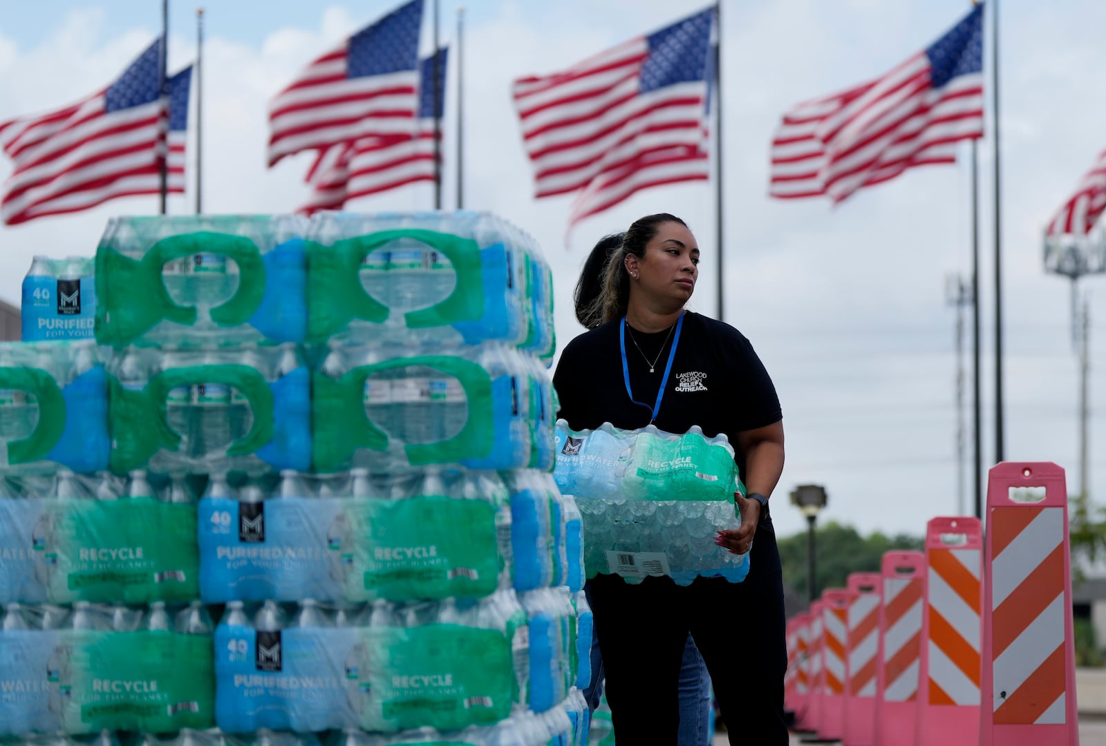 FILE - Staff at Lakewood Church hand out water and operate a cooling station in Houston, July 9, 2024. (AP Photo/Eric Gay, File)