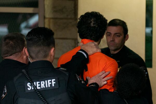 Suspect Luigi Mangione is taken into the Blair County Courthouse on Tuesday, Dec. 10, 2024, in Hollidaysburg, Pa. (Benjamin B. Braun/Pittsburgh Post-Gazette via AP)