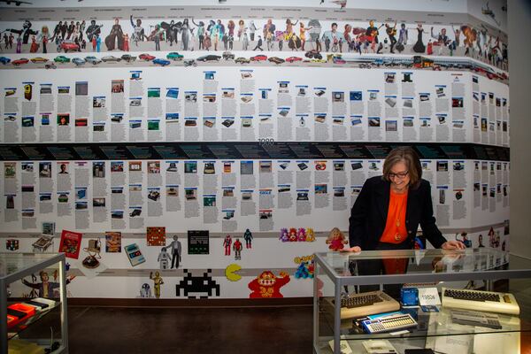 Executive Director Rena Youngblood talks about a display near a wall of history at the Computer Museum of America. PHIL SKINNER FOR THE ATLANTA JOURNAL-CONSTITUTION.