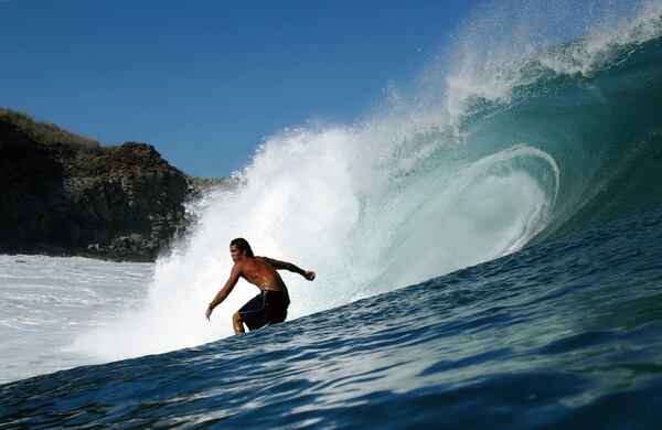 KAPALUA, HAWAII - JANUARY 10:  Surfer Chris Stor drops into a large wave during a large swell on January 10, 2004 at Windmills in Kapalua, Maui, Hawaii. (Photo by Donald Miralle/Getty Images)