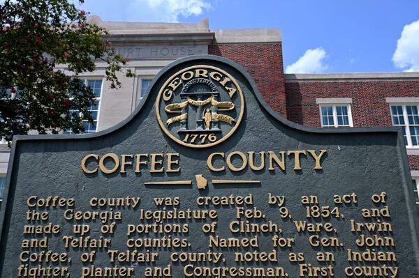 A sign outside the Coffee County Courthouse in downtown Douglas traces the county's history. (Hyosub Shin / Hyosub.Shin@ajc.com)