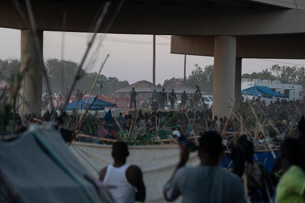 FILE - Migrants near the Del Rio International Bridge in Del Rio, Texas, Sept. 17, 2021. The U.S. and Mexico began overhauling an aged security agreement on Friday to better confront the flow of criminal activity between the two nations, but officials at the high-level talks conspicuously sought to avoid focusing on the ever-growing migrant crisis on their shared border. (Verónica G. Cárdenas/The New York Times)