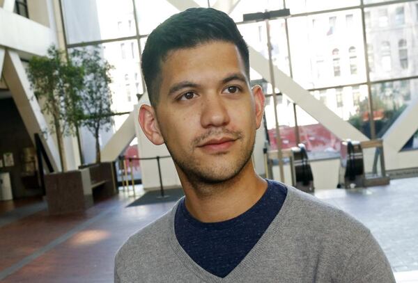 In this Friday, Sept. 7, 2018 photo, Chris Damian poses in Minneapolis. Damian believes having more nuanced conversations about hard topics like sex abuse by priests and allegations of cover-ups by church leaders can bring about change. Damian, 27, has organized a group of Catholic young adults to respond to the church crisis. (AP Photo/Jim Mone)