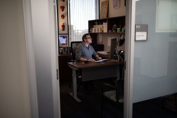 Georgia State University Professor Dr. Volkan Topalli works at his office in downtown, Wednesday, Dec. 22, 2021, in Atlanta.  Volkan was shot in the arm when gunfire erupted while shopping at a Home Depot. (BRANDEN CAMP FOR THE ATLANTA JOURNAL-CONSTITUTION)