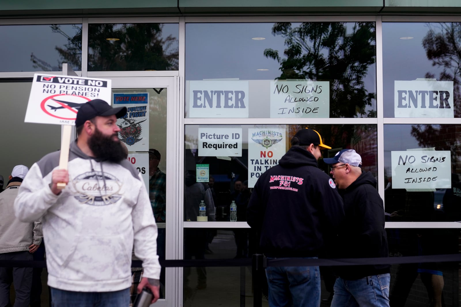 Boeing employees on strike enter a voting location to cast their ballots on a new contract offer from the company, Wednesday, Oct. 23, 2024, at the Angel of the Winds Arena in Everett, Wash. (AP Photo/Lindsey Wasson)