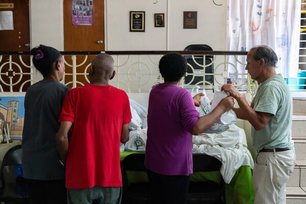 Volunteers at San Pablo Methodist Church pack food into bags to donate to the immigrant community in Barrio Obrero, San Juan, Puerto Rico, Friday, March 14, 2025. (AP Photo/Alejandro Granadillo)