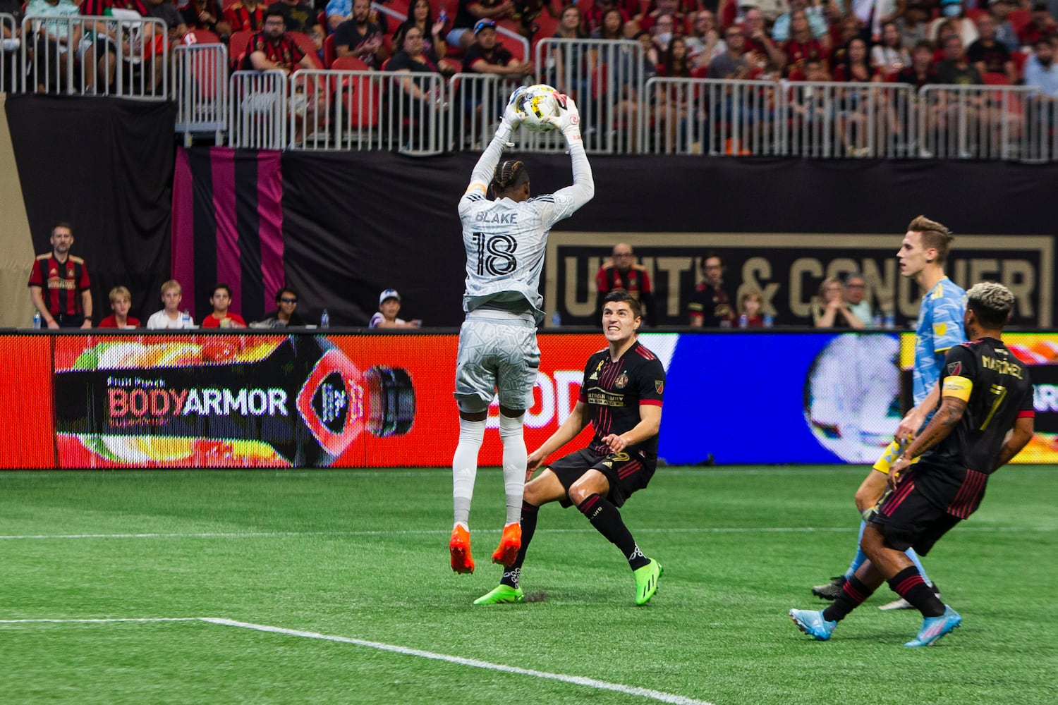 Philadelphia Union goalie Andre Blake makes a save with pressure from Ronaldo Cisneros of Atlanta United. CHRISTINA MATACOTTA FOR THE ATLANTA JOURNAL-CONSTITUTION.