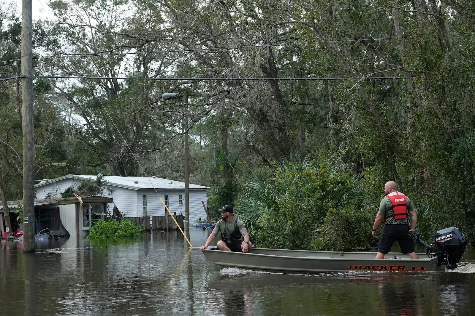 Members of the Hillsborough County Sheriff's office drive a boat through floodwaters from Hurricane Milton near the Alafia River Friday, Oct. 11, 2024, in Lithia, Fla. (AP Photo/Chris O'Meara)