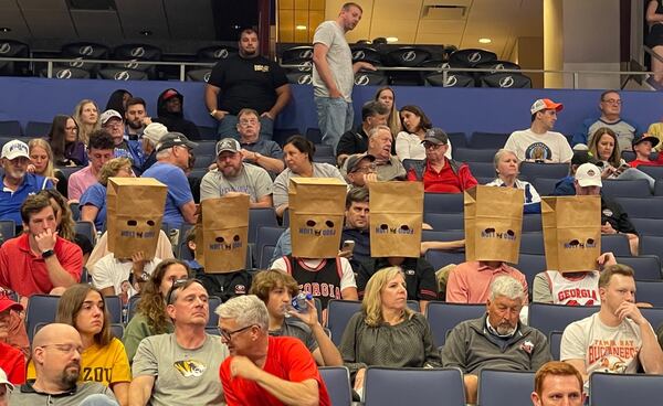 A group of Georgia basketball fans at Amalie Arena in Tampa cover their heads with paper sacks in shame of the way the Bulldogs played in the first half against Vanderbilt during the SEC Tournament on Wednesday. Georgia trailed 35-14 at halftime, scoring their fewest points in a half this season. (Photo by Chip Towers/ctowers@ajc.com)