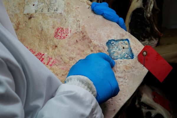 John Jobbagy shows his stamp on a cut of beef during an interview at J.T. Jobbagy Inc. in the Meatpacking District of Manhattan, Tuesday, Nov. 19, 2024, in New York. (AP Photo/Julia Demaree Nikhinson)