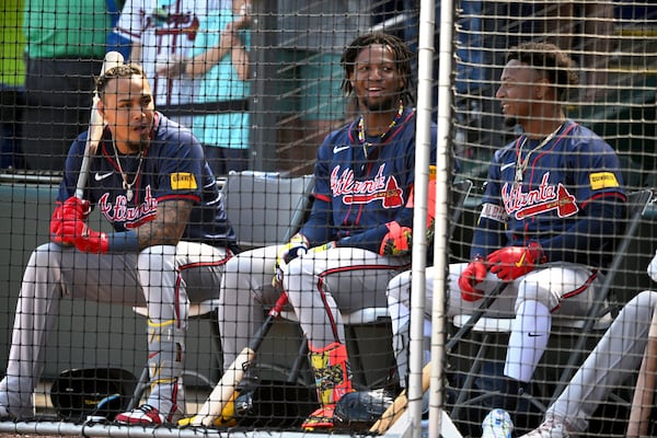 Braves shortstop Orlando Arcia (from left), right fielder Ronald Acuna Jr. and second baseman Ozzie Albies chat during 2024 spring training. (Hyosub Shin/AJC)