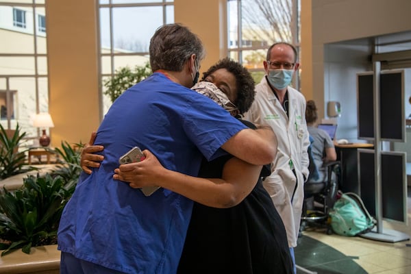 Radiologist Matthew McClain embraces Josetta Cooke at Floyd Medical Center in Rome earlier this week. McClain helped to diagnose Cooke one year ago. (Alyssa Pointer / Alyssa.Pointer@ajc.com)