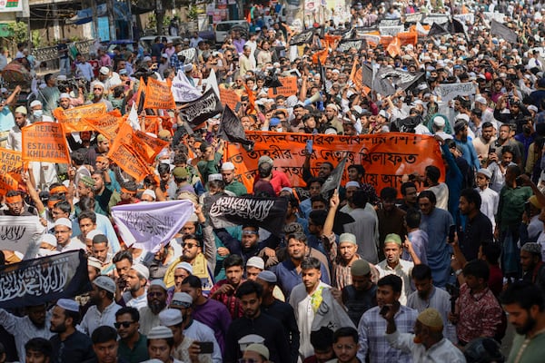 Members and supporters of the banned Islamist group Hizbut Tahrir march near Baitul Mokarram Mosque in Dhaka, Bangladesh, Friday, March 7, 2025. (AP Photo/Mahmud Hossain Opu)