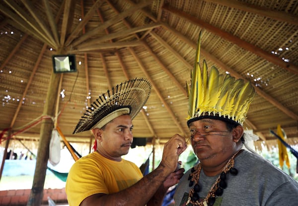 Members of the Mura Indigenous community perform traditional painting at a gathering in the Moyray village, in Autazes, Amazonas state, Brazil, Friday, Feb. 21, 2025. (AP Photo/Edmar Barros)