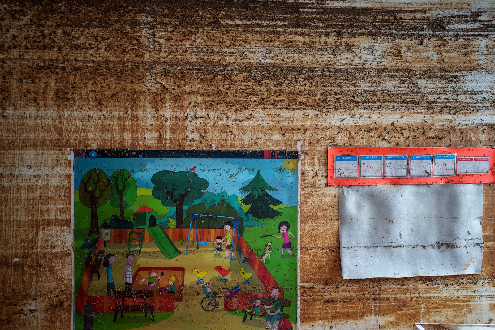 Children's drawings hang on the wall of a daycare center, showing the water level in area affected by floods in Valencia, Spain, Saturday, Nov. 2, 2024. (AP Photo/Manu Fernandez)