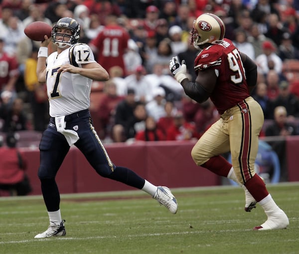 San Diego Chargers quarterback Philip Rivers (17) passes in front of San Francisco 49ers defensive end Bryant Young (97) in the first quarter of their NFL football game, Sunday, Oct. 15, 2006 in San Francisco. The 49ers lost to the San Diego Chargers 48-19. (AP Photo/Paul Sakuma)