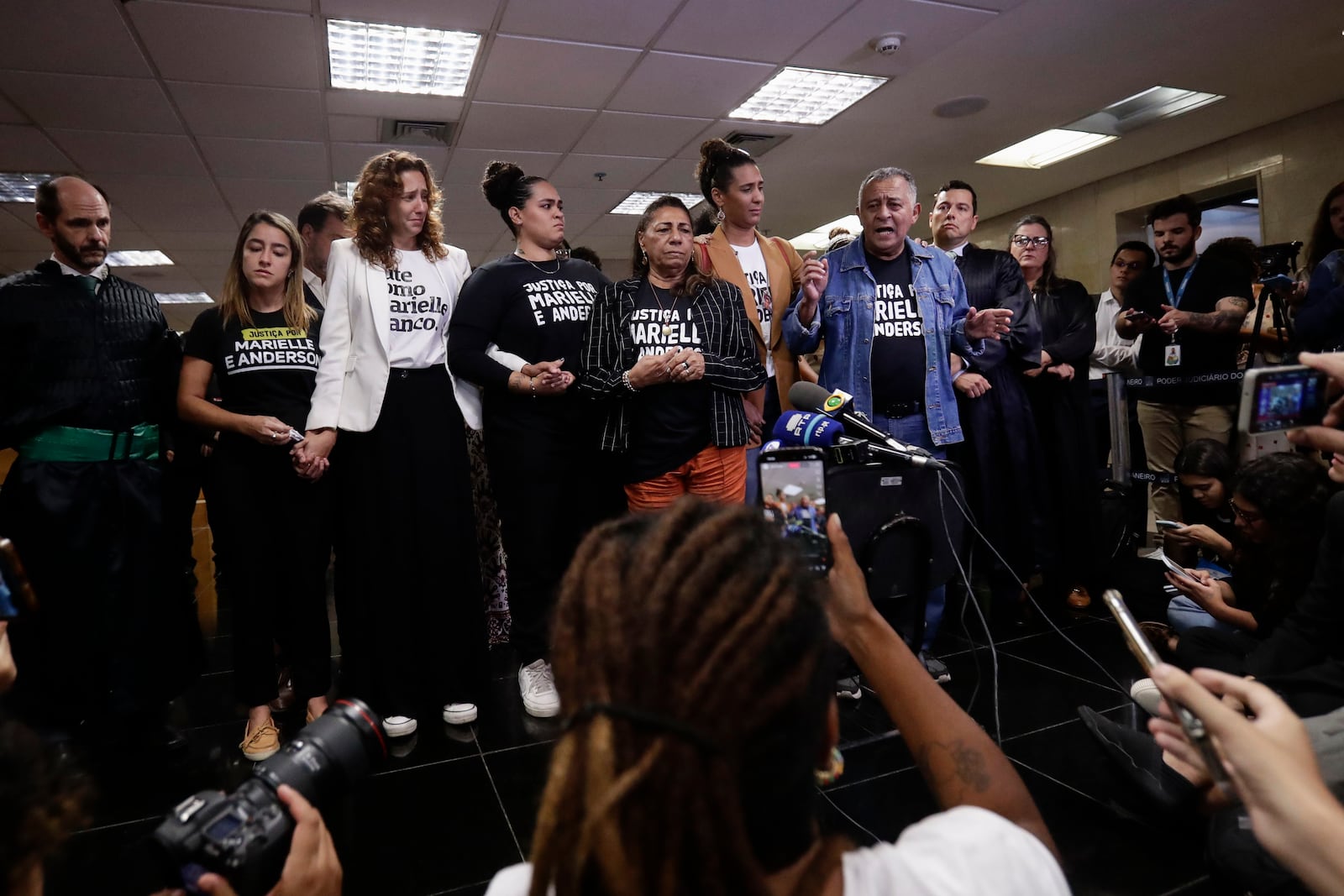 Family members of slain councilwoman Marielle Franco address the press after a judge sentenced two former police officers for the 2018 murder of Franco and her driver Anderson Gomes, at the Court of Justice in Rio de Janeiro, Thursday, Oct. 31, 2024. (AP Photo/Bruna Prado)