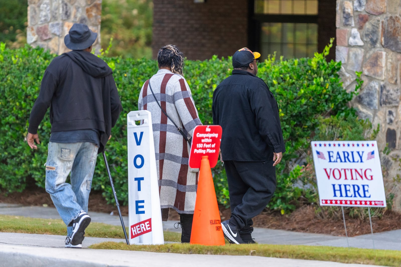 Voters are seen entering the polling station, Thursday, Oct. 31, 2024, in Stockbridge, Ga. (AP Photo/Jason Allen)