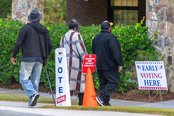 Voters are seen entering the polling station, Thursday, Oct. 31, 2024, in Stockbridge, Ga. (AP Photo/Jason Allen)