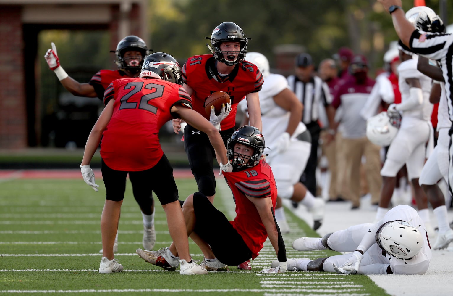 Cherokee defensive back Riley Lyons (19) reacts with teammates after intercepting a pass intended for Carver-Atlanta wide receiver Qintavious Davis (6) in the first half at Cherokee high school Wednesday, September 2, 2020 in Canton, Ga.. The Carver-Atlanta at Cherokee game is the first football game of the 2020 Corky Kell Classic. JASON GETZ FOR THE ATLANTA JOURNAL-CONSTITUTION