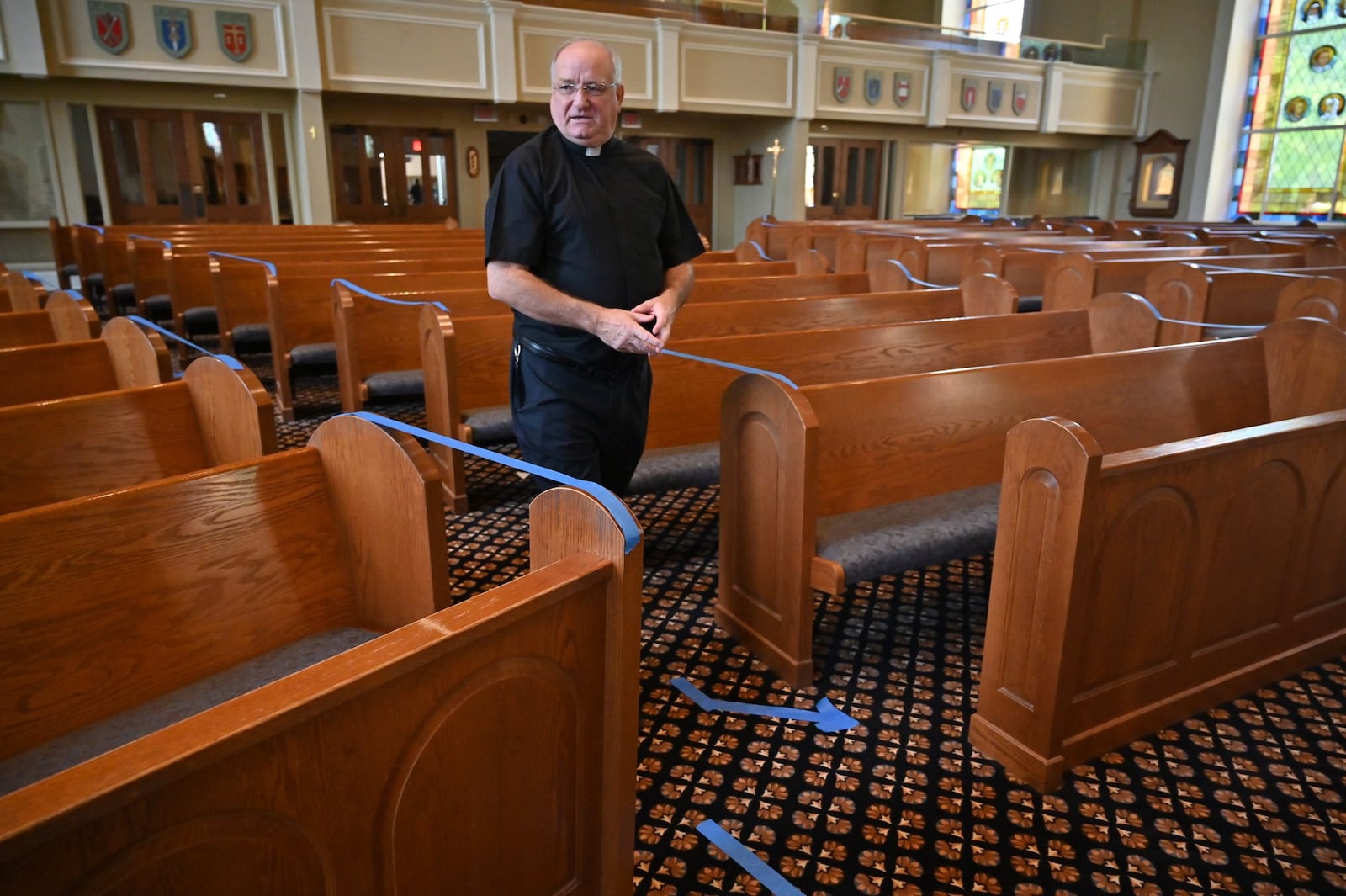 On Saturday, May 23, 2020, Father Paul Flood checks social distancing measures in preparation for Monday’s planned resumption of daily Mass at St. Benedict Catholic Church in Johns Creek. (Hyosub Shin / Hyosub.Shin@ajc.com)