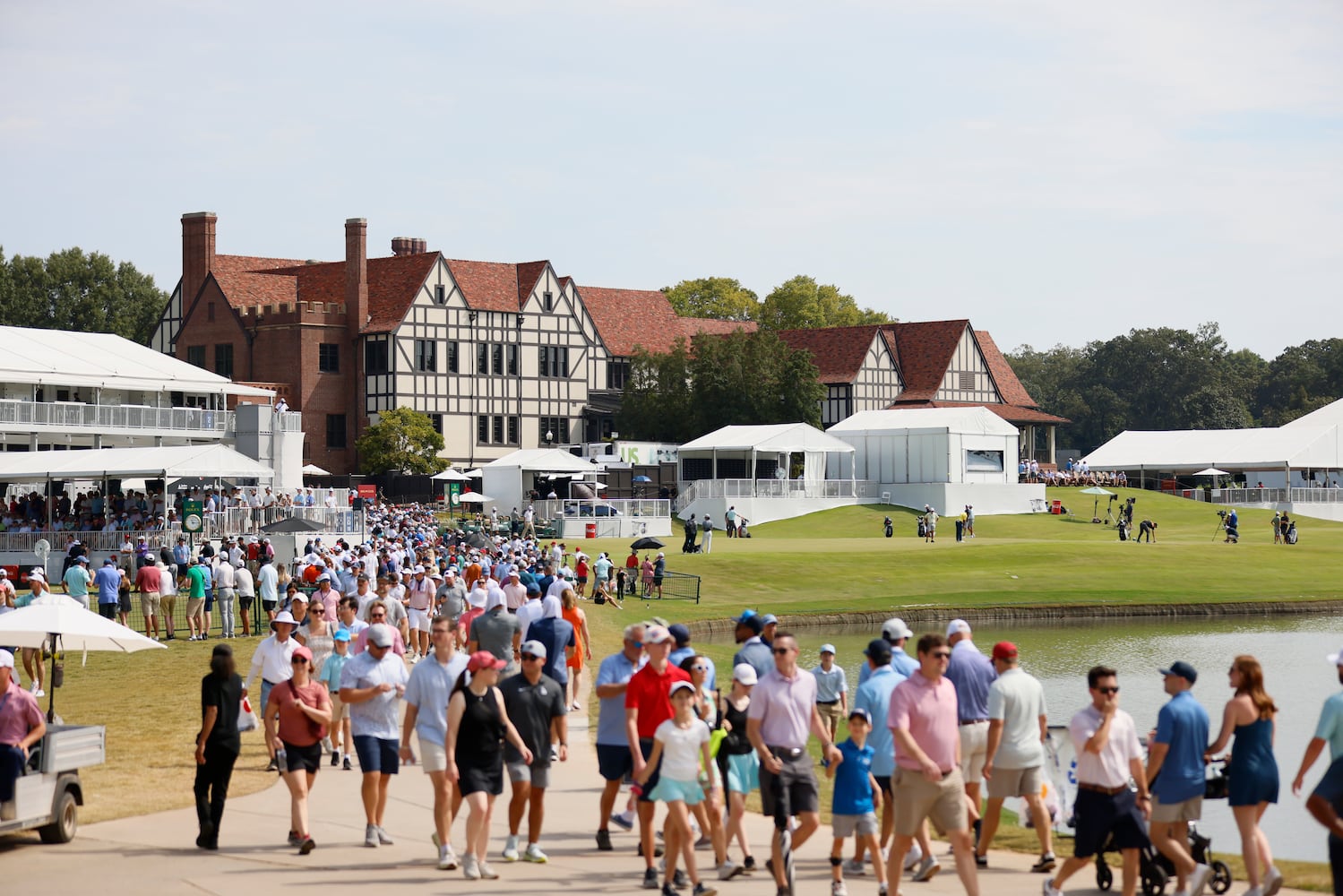 Fans walk near the driving range during the final round of the Tour Championship at East Lake Golf Club on Sunday, Sept. 1, 2024, in Atlanta. 
(Miguel Martinez / AJC)