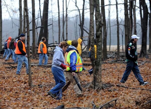 FILE - Volunteers and rescuers search for 9-year-old Andrew, 7-year-old Alexander and 5-year-old Tanner Skelton in Morenci, Mich. on Tuesday, Nov. 30, 2010. (David Coates/Detroit News via AP, File)