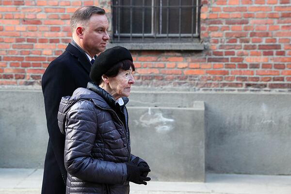 Poland's President Andrzej Duda and Zofia Optulowicz, the daughter of Polish World War II resistance leader Witold Pilecki, attend a wreath-laying ceremony Monday at the Auschwitz Nazi death camp in Oswiecim, Poland.