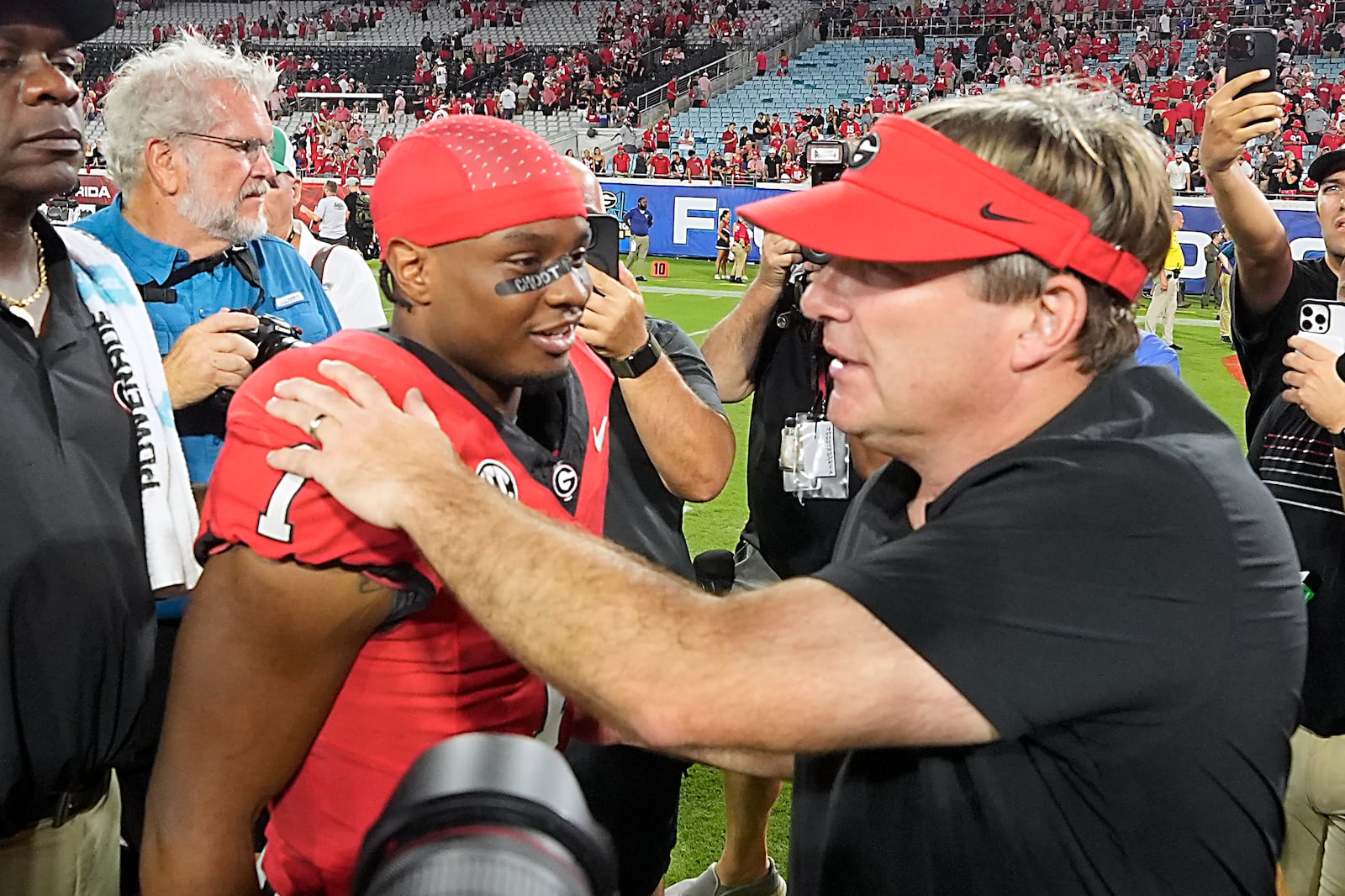 Georgia running back Trevor Etienne, left, and head coach Kirby Smart celebrate after defeating Florida in an NCAA college football game, Saturday, Nov. 2, 2024, in Jacksonville, Fla. (AP Photo/John Raoux)