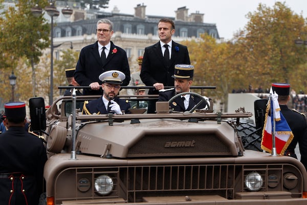 French President Emmanuel Macron, right, and Britain's Prime Minister Keir Starmer review troops aboard a command car during commemorations marking the 106th anniversary of the November 11, 1918, Armistice, ending World War I, at the Arc de Triomphe in Paris, Monday, Nov. 11, 2024. ( Ludovic Marin, Pool via AP)