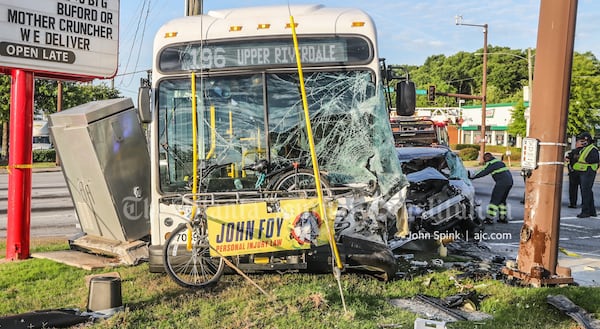 A MARTA bus with significant front-end damage and a crumpled passenger car are shown at the scene of a wreck on Ga. 85. (John Spink/AJC)