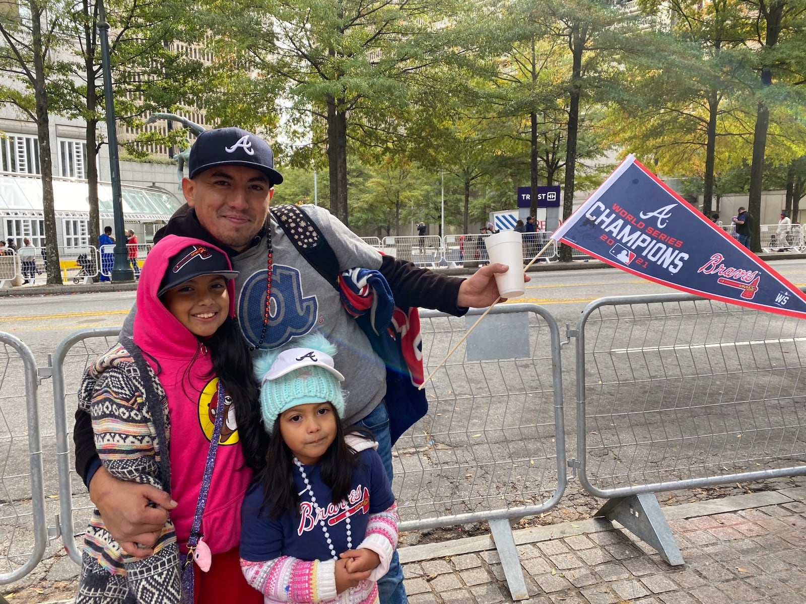 Daniel Gonzalez brought Katherine, 9, and Kellie Rodriguez, 5, to the Braves parade, where a highlight was seeing Blooper and their favorite players. VANESSA McCRAY/AJC 