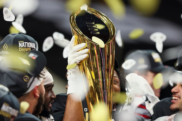 An Ohio State player celebrate with the national championship trophy after their 34-23 win against Notre Dame in the 2025 National Championship at Mercedes-Benz Stadium, Monday, Jan. 20, 2025, in Atlanta. (Jason Getz / AJC)