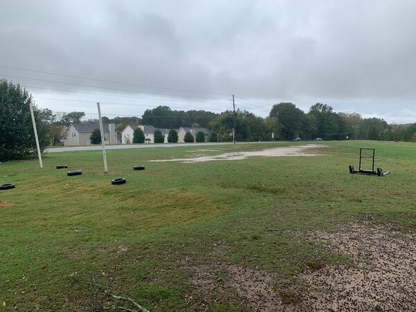 Hapeville Charter's practice field is less than 100 yards long and 50 yards wide, is uneven, has dirt patches and divots and is cut off by a sidewalk that separates the field and Buffington Road. (Courtesy of Hapeville Charter)