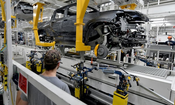 Manufacturing workers assemble the R1T electric vehicle at Rivian in Normal, Ill., on July 20, 2022. (Photo for The Atlanta Journal-Constitution by Ron Johnson)