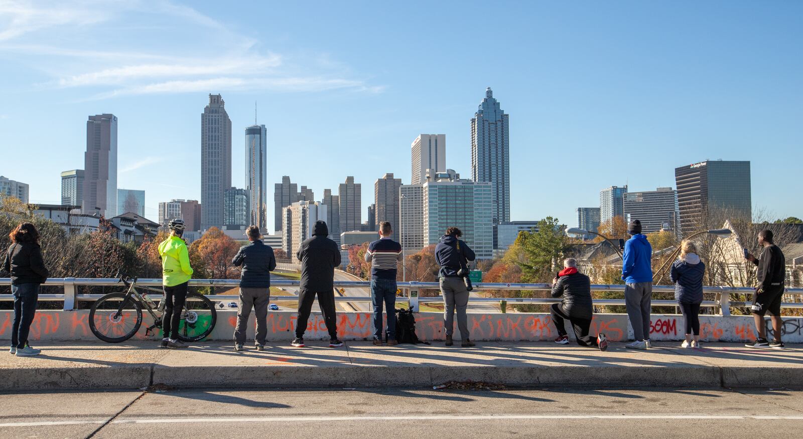 Local supporters and media gather on the Jackson Street Bridget to view the motorcade accompanying Rosalynn Carter along Freedom Parkway to the Carter Center on Monday, Nov 27, 2023.  Carter’s funeral is Tuesday, Nov 28, 2023 on Emory University campus. (Jenni Girtman for The Atlanta Journal-Constitution)