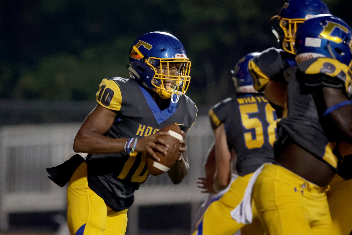 Chattahoochee quarterback Jaylen Smith (10) rolls out of the pocket in the first half against Alpharetta at Chattahoochee high school Friday, September 25, 2020 in Johns Creek, Ga.. JASON GETZ FOR THE ATLANTA JOURNAL-CONSTITUTION