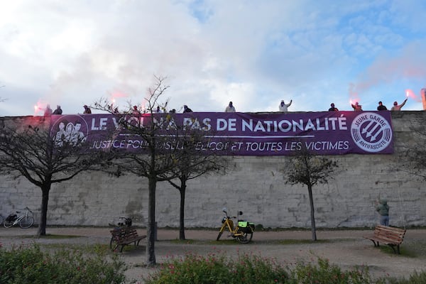 Activists display a banner reading "Rape has no nationality" during a women's rights demonstration, Saturday, Dec. 14, 2024 in Avignon, southern France, where the trial of dozens of men accused of raping Gisèle Pelicot while she was drugged and rendered unconscious by her husband is taking place. (AP Photo/Aurelien Morissard)