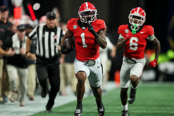 Georgia running back Trevor Etienne (center) goes for a 48-yard run during the third quarter against Texas in the 2024 SEC Championship at Mercedes-Benz Stadium in Atlanta on Dec. 7. Georgia won 22-19 in overtime. (Jason Getz/AJC)
