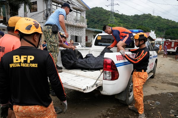 A body is recovered by rescuers after a recent landslide triggered by Tropical Storm Trami struck Talisay, Batangas province, Philippines which thousands homeless and several villagers dead on Saturday, Oct. 26, 2024. (AP Photo/Aaron Favila)